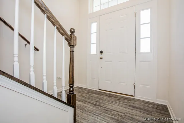 a view of an entryway with wooden floor
