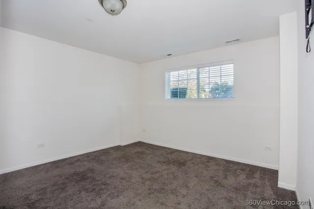 a view of an empty room with windows