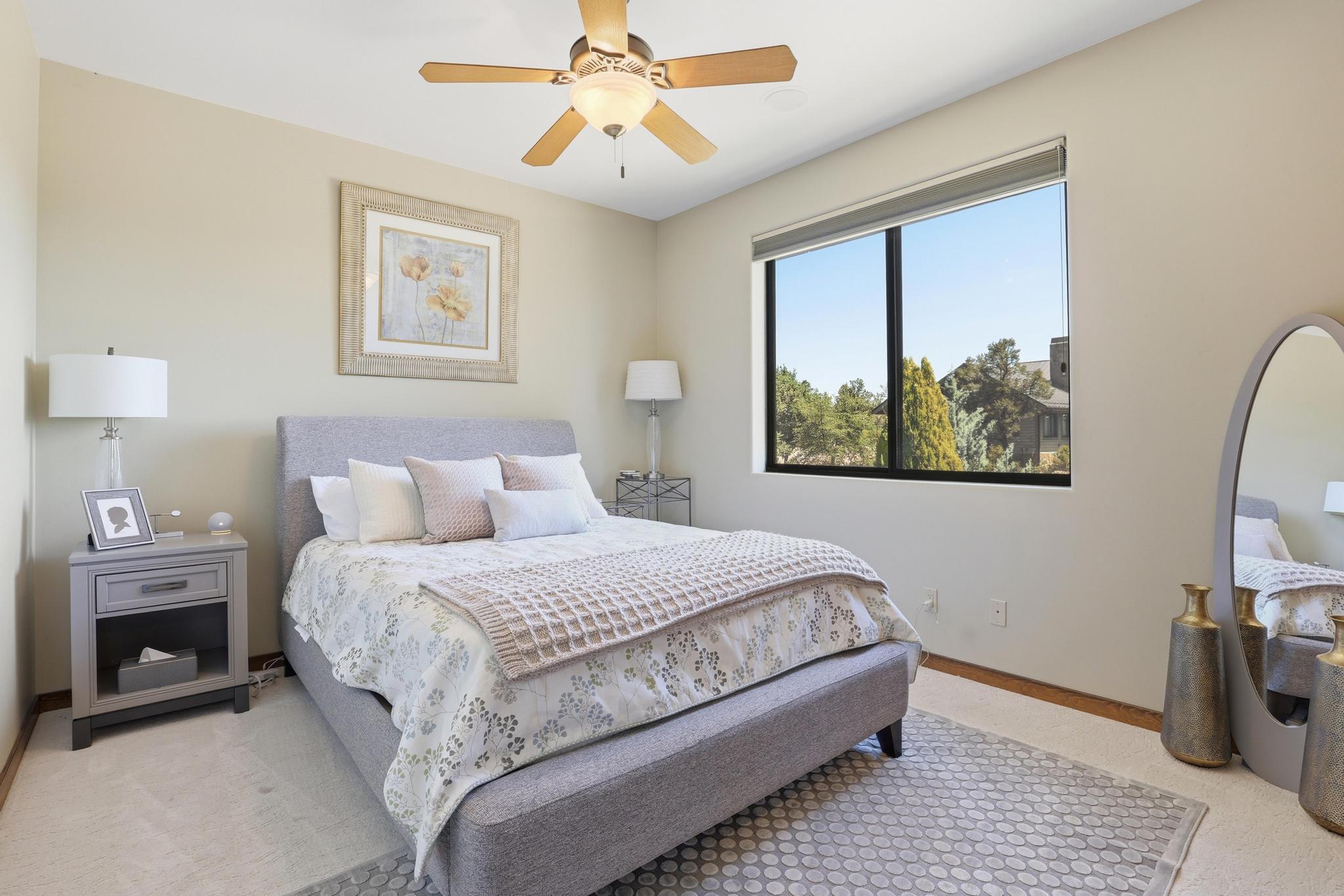 2908 East Rim Club Drive Payson, AZ 85541 - Photo 27 of 77 a bedroom with a bed and a chandelier