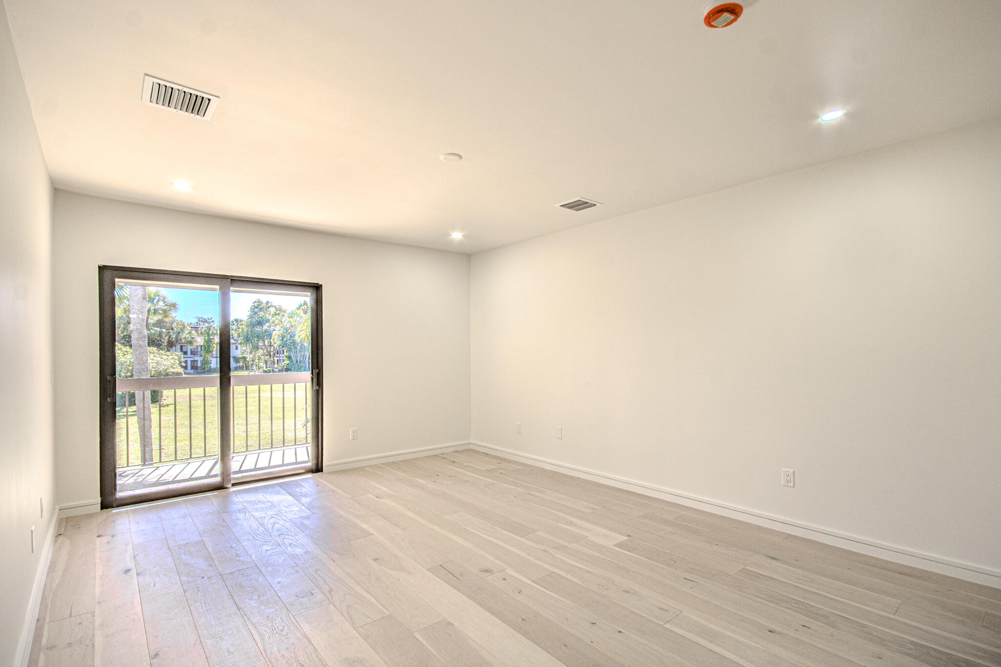 13334 Polo Club Road, Unit 348 Wellington, FL 33414 - Photo 19 of 43 an empty room with wooden floor and windows