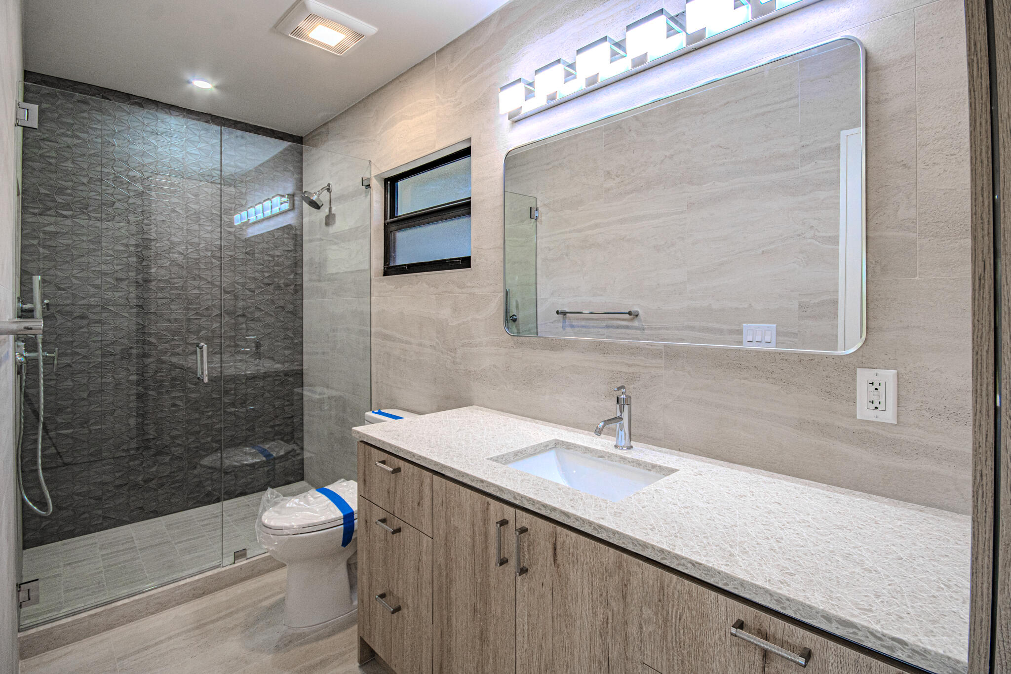 13334 Polo Club Road, Unit 348 Wellington, FL 33414 - Photo 21 of 43 a bathroom with a sink a toilet and shower