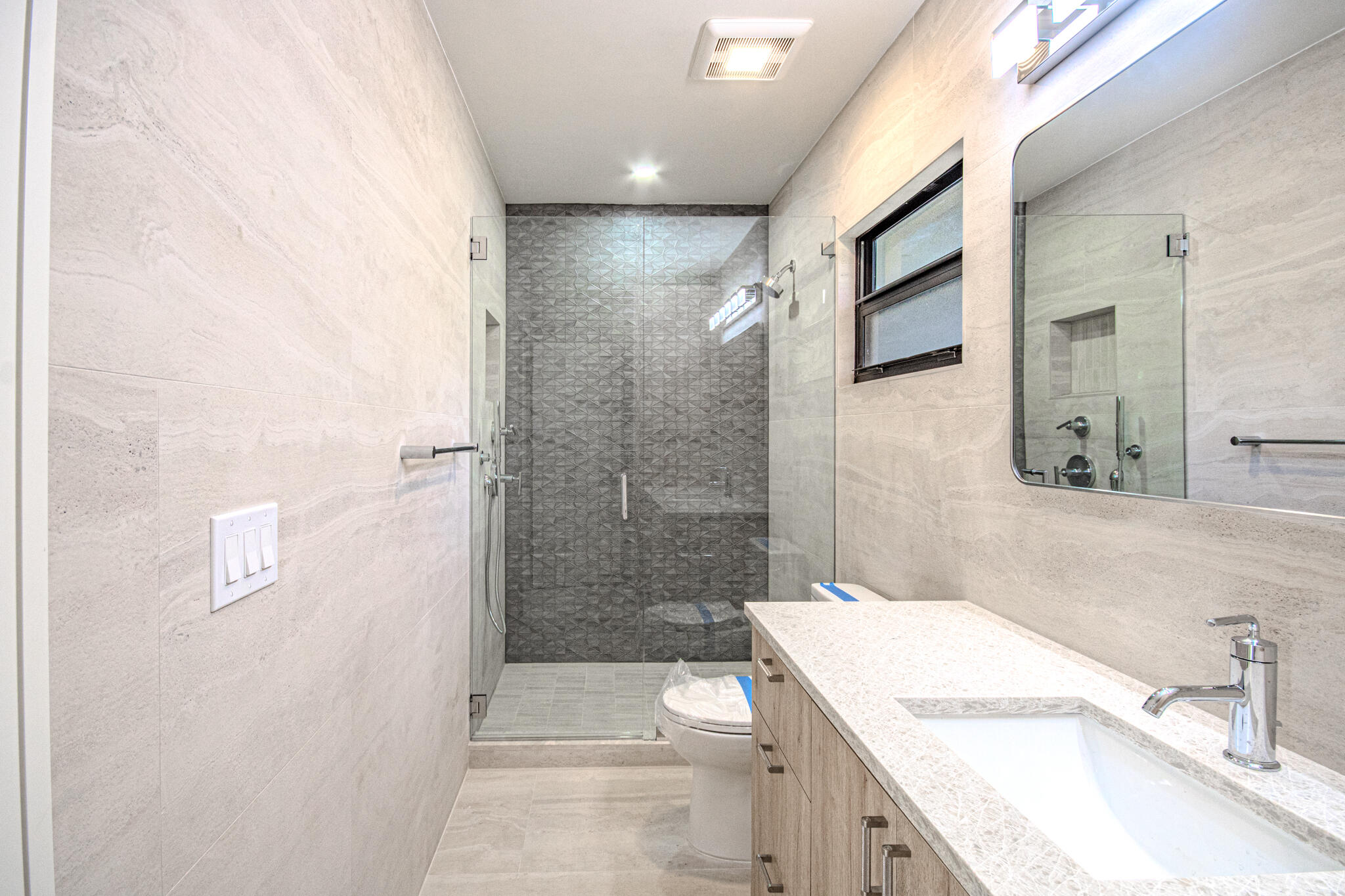 13334 Polo Club Road, Unit 348 Wellington, FL 33414 - Photo 22 of 43 a bathroom with a granite countertop sink a toilet and shower