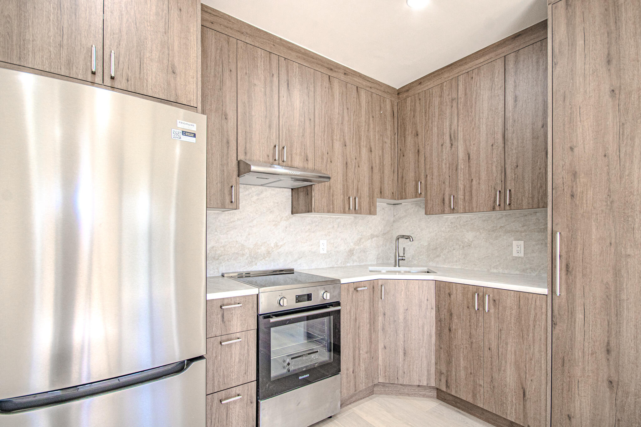 13334 Polo Club Road, Unit 348 Wellington, FL 33414 - Photo 30 of 43 a kitchen with stainless steel appliances granite countertop a refrigerator sink and stove