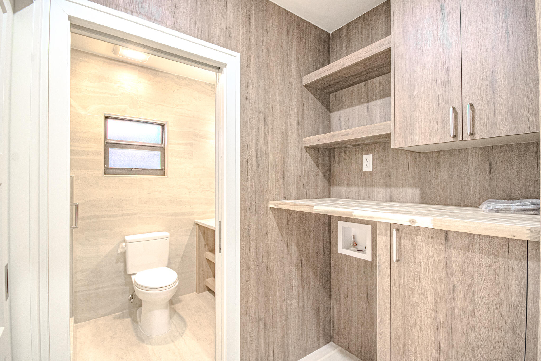 13334 Polo Club Road, Unit 348 Wellington, FL 33414 - Photo 33 of 43 a bathroom with a sink a toilet and a window