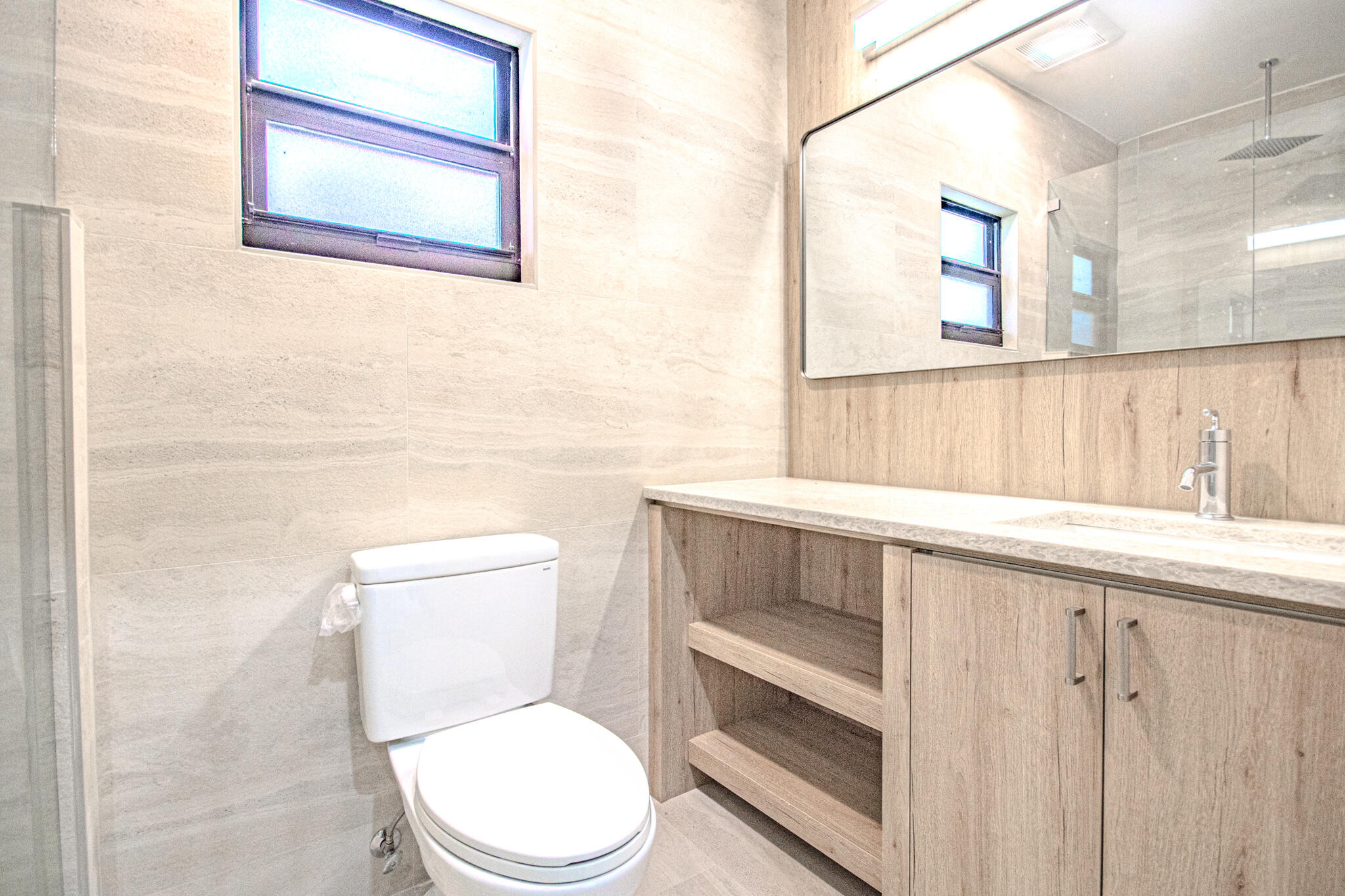 13334 Polo Club Road, Unit 348 Wellington, FL 33414 - Photo 35 of 43 a bathroom with a toilet a sink and a window