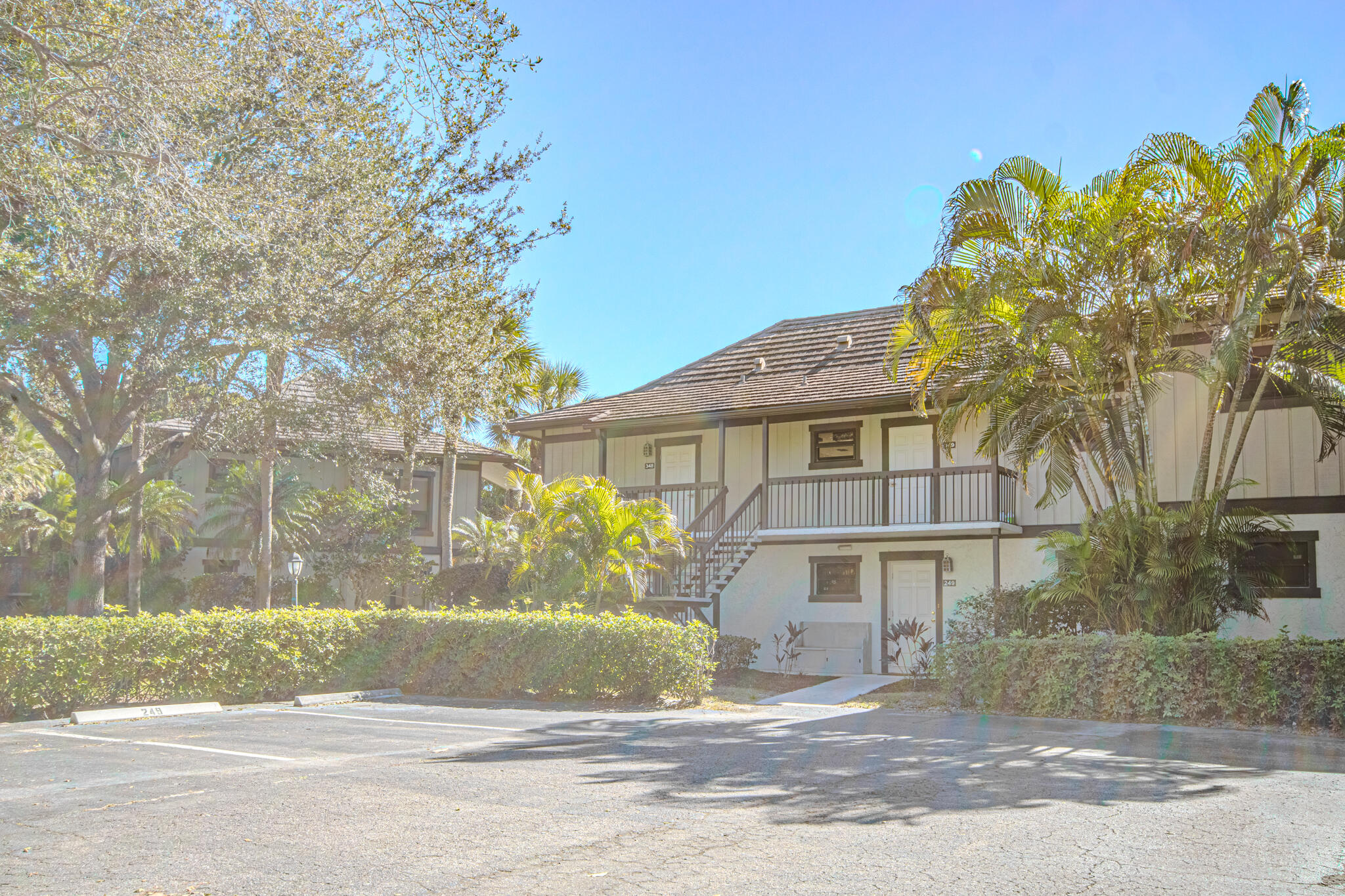 13334 Polo Club Road, Unit 348 Wellington, FL 33414 - Photo 40 of 43 a front view of a house with a yard and garage