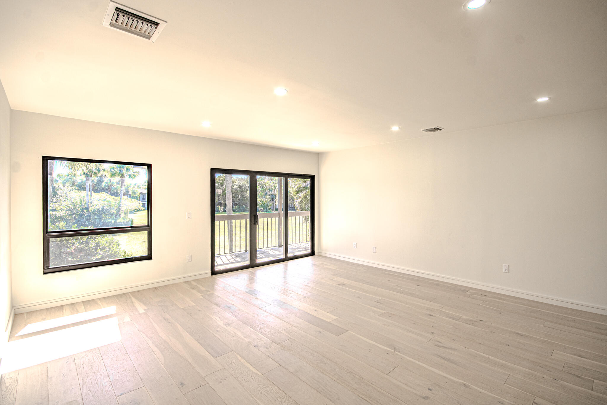 13334 Polo Club Road, Unit 348 Wellington, FL 33414 - Photo 10 of 43 an empty room with wooden floor and windows