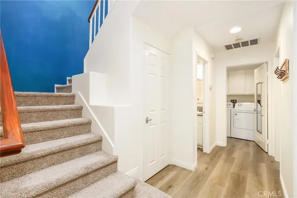 a view of entryway and hall with wooden floor