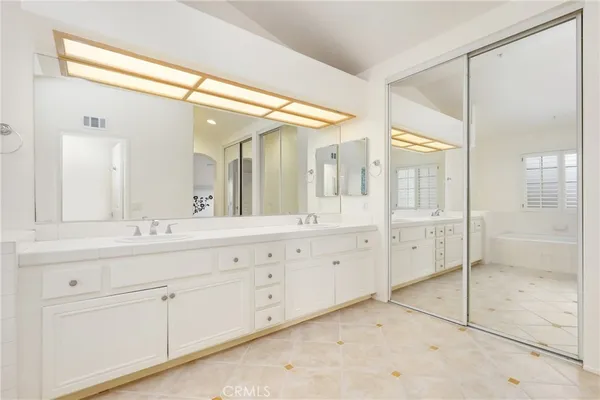 a bathroom with a granite countertop sink mirror and