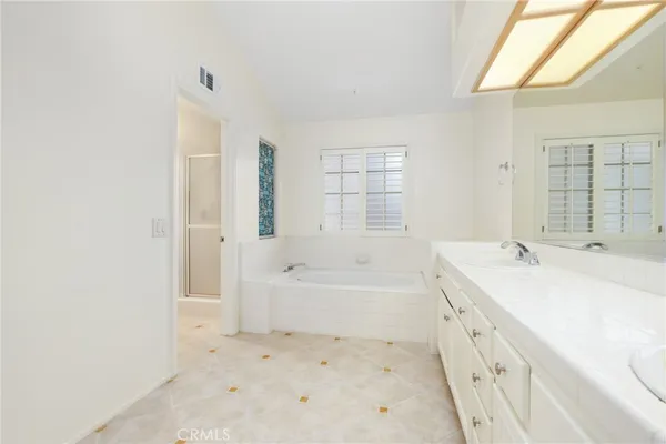 a bathroom with a bathtub sink and a shower