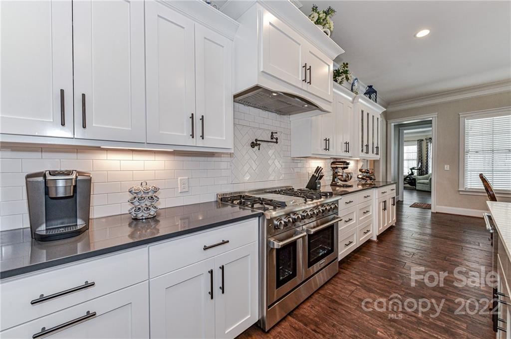9625 Kerr Road Indian Trail, NC 28079 - Photo 12 of 48 a kitchen with stainless steel appliances granite countertop a stove a sink and white cabinets