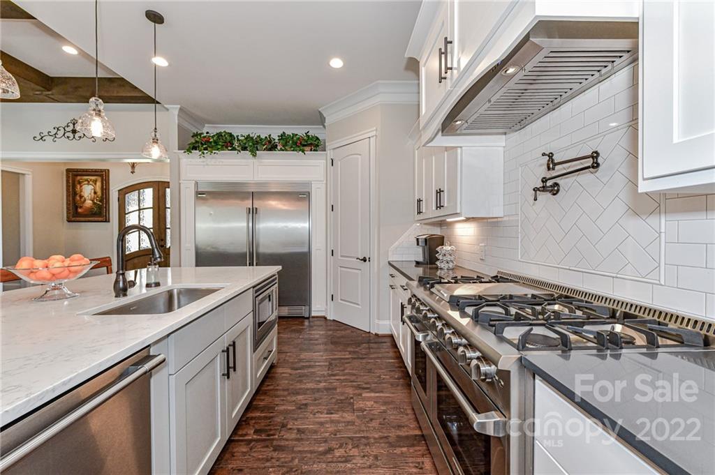 9625 Kerr Road Indian Trail, NC 28079 - Photo 13 of 48 a kitchen with stainless steel appliances granite countertop a stove and a refrigerator