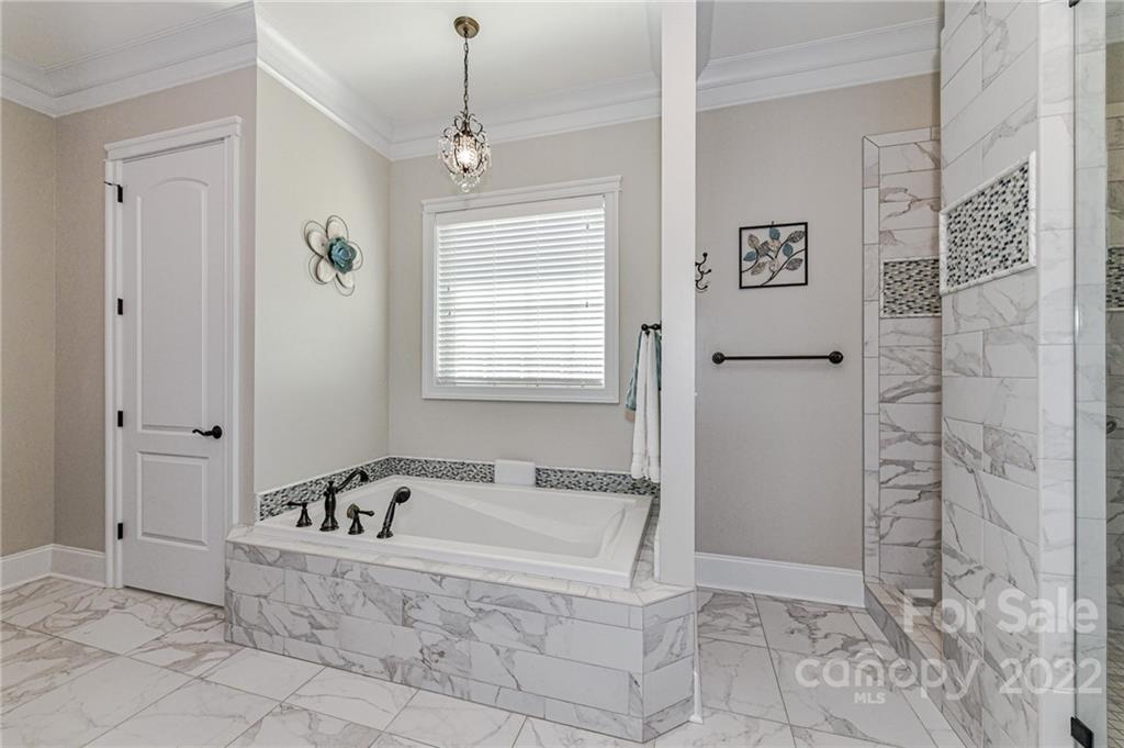9625 Kerr Road Indian Trail, NC 28079 - Photo 20 of 48 a bathroom with a bathtub and shower