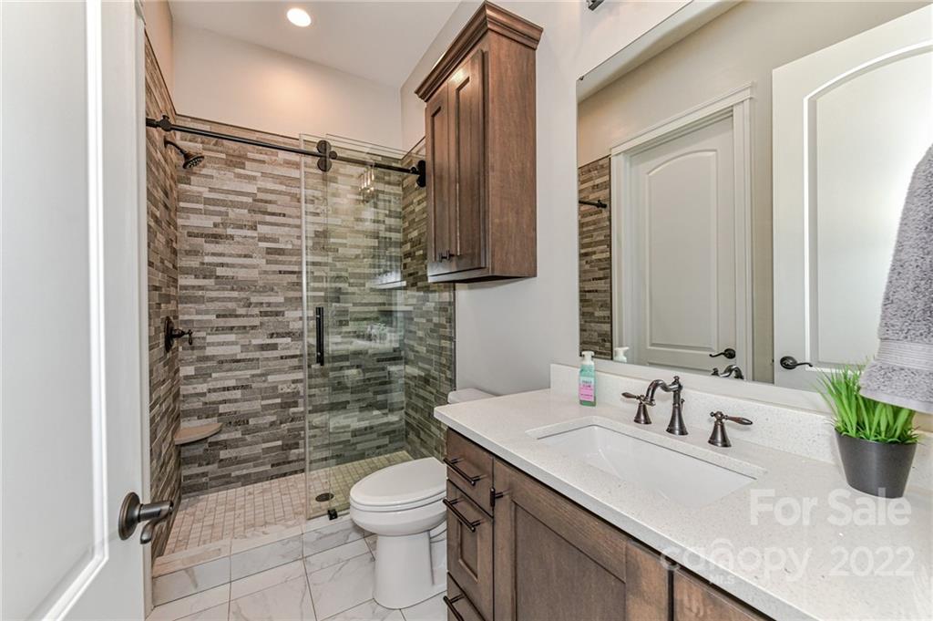9625 Kerr Road Indian Trail, NC 28079 - Photo 27 of 48 a bathroom with a sink a toilet and shower