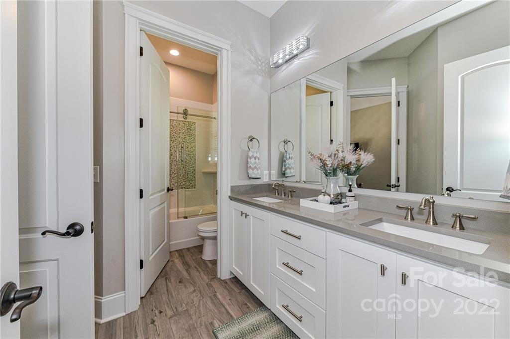 9625 Kerr Road Indian Trail, NC 28079 - Photo 30 of 48 a spacious bathroom with a granite countertop sink double mirror and a toilet