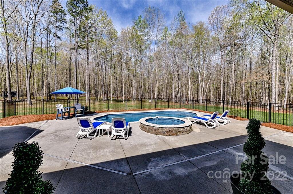 9625 Kerr Road Indian Trail, NC 28079 - Photo 41 of 48 a view of a patio with table and chairs potted plants with wooden fence
