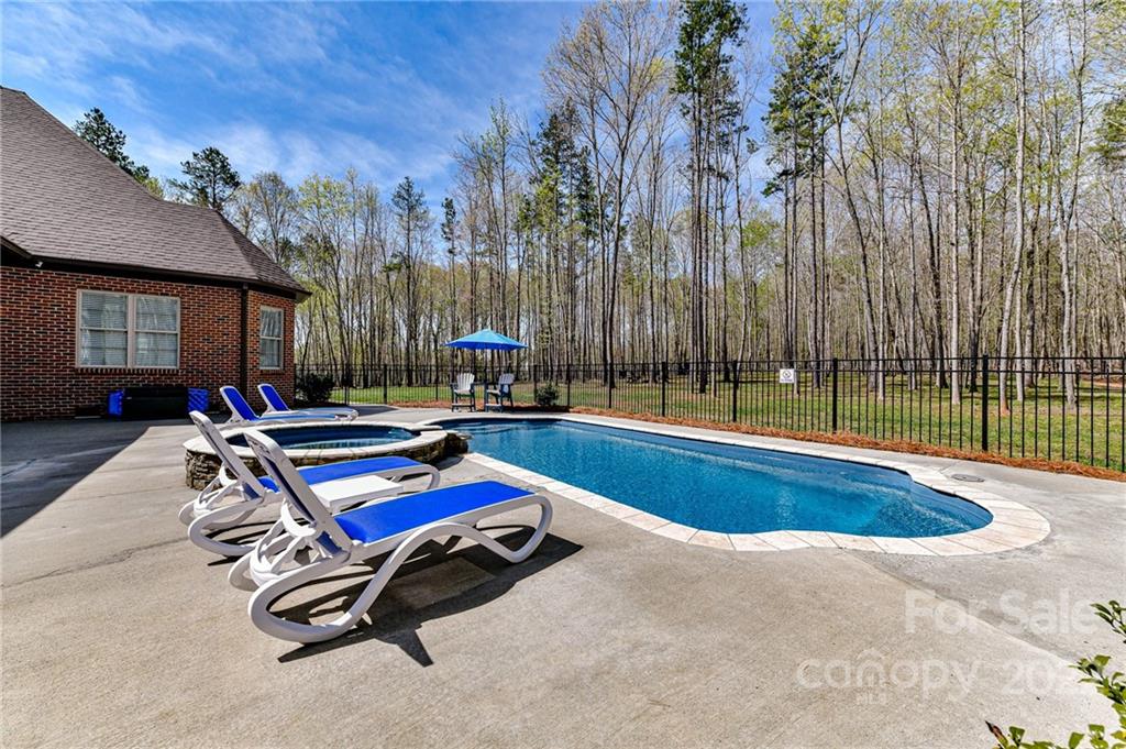 9625 Kerr Road Indian Trail, NC 28079 - Photo 42 of 48 a swimming pool with outdoor seating and yard