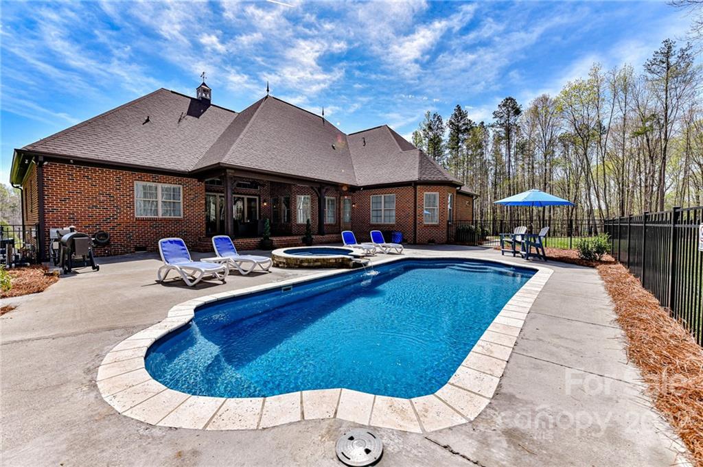 9625 Kerr Road Indian Trail, NC 28079 - Photo 43 of 48 a swimming pool with outdoor seating yard and livingroom view