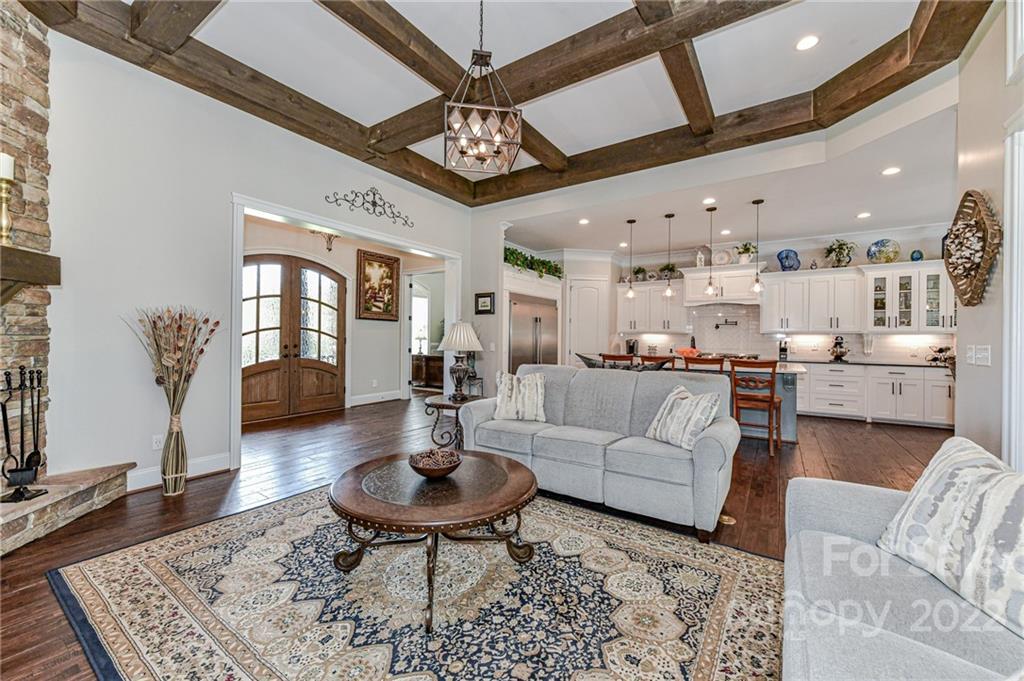 9625 Kerr Road Indian Trail, NC 28079 - Photo 9 of 48 a living room with furniture and a chandelier