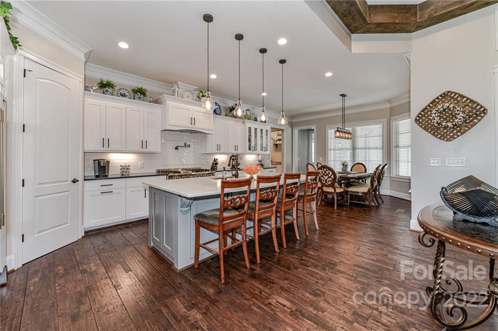 9625 Kerr Road Indian Trail, NC 28079 - Photo 10 of 48 a kitchen with stainless steel appliances a dining table chairs stove and cabinets