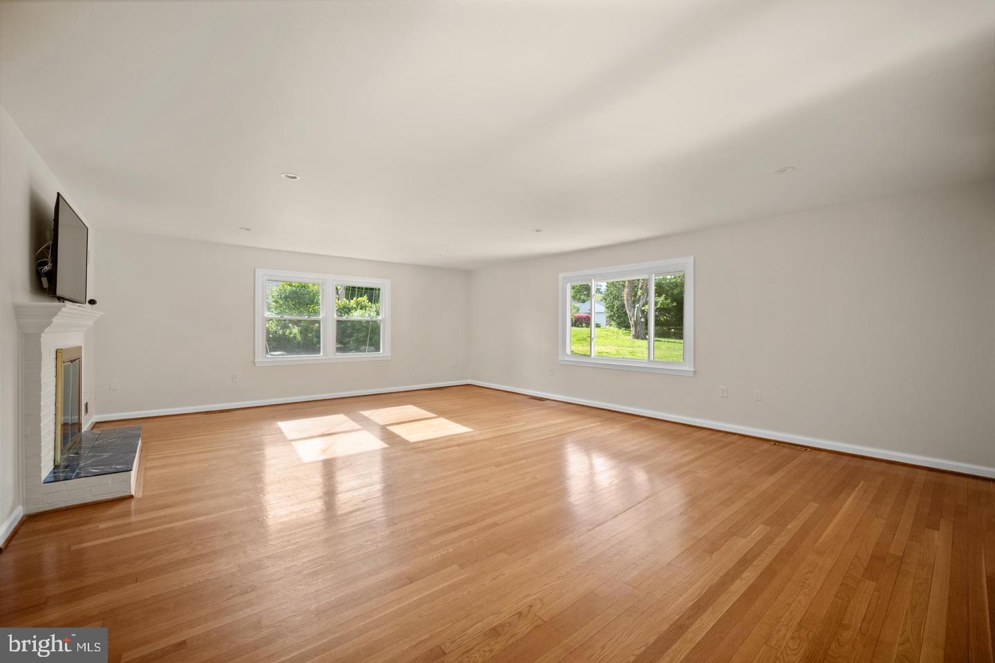 705 Halstead Road Wilmington, DE 19803 - Photo 4 of 31 an empty room with wooden floor and windows