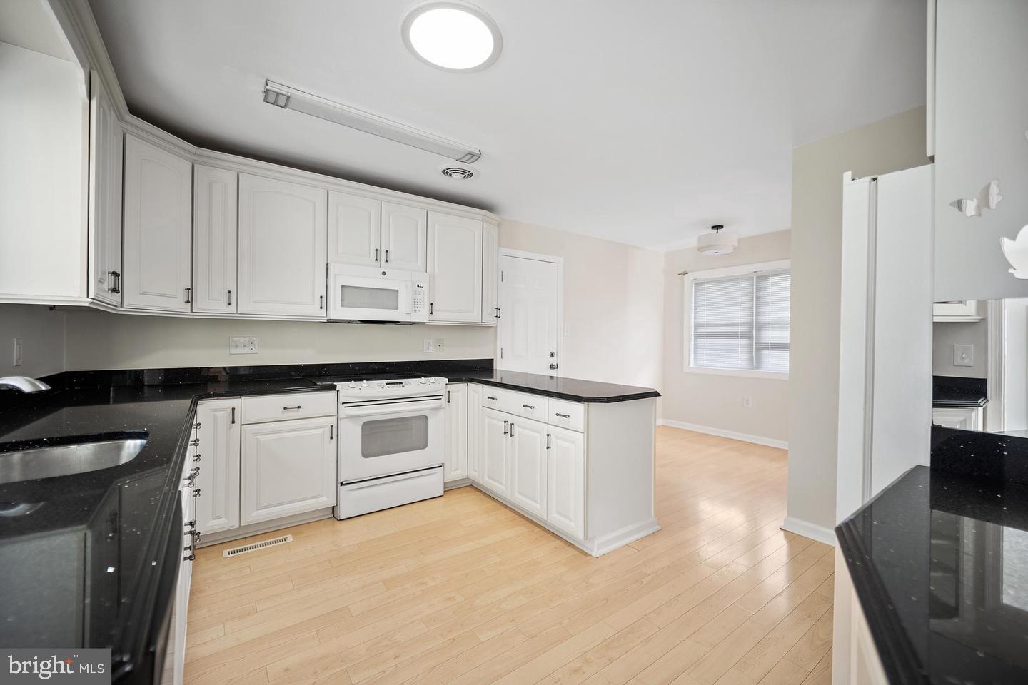 705 Halstead Road Wilmington, DE 19803 - Photo 10 of 31 a kitchen with granite countertop white cabinets and white appliances