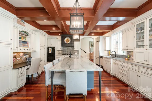 a large kitchen with a table and chairs