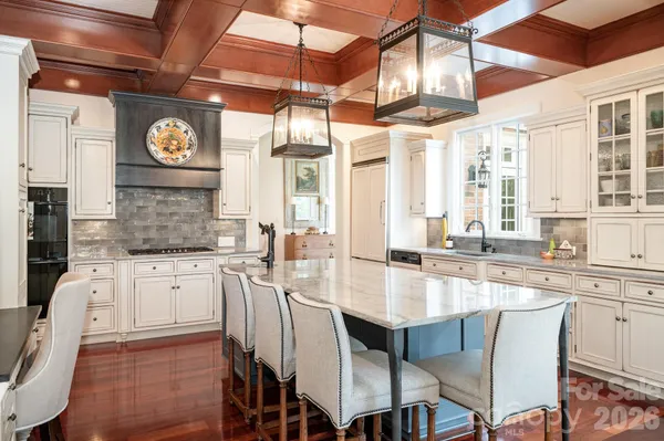 a large kitchen with a table and chairs