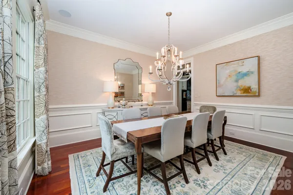 a view of a dining room with furniture and chandelier