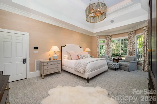 a bedroom with a bed and a chandelier