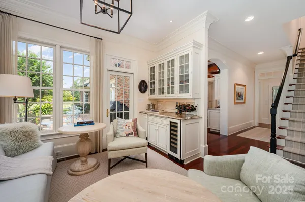 a living room with furniture a air conditioner vent and a large window