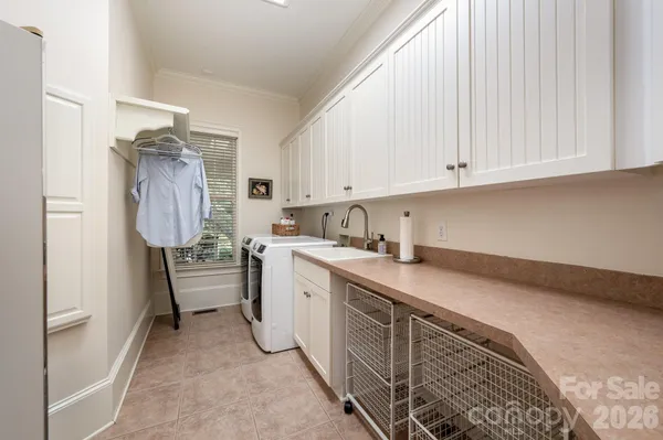 a kitchen with refrigerator and cabinets