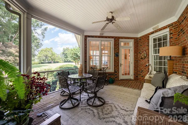 a living room filled with furniture and a potted plant