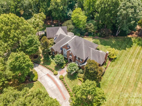 an aerial view of a house with swimming pool and garden