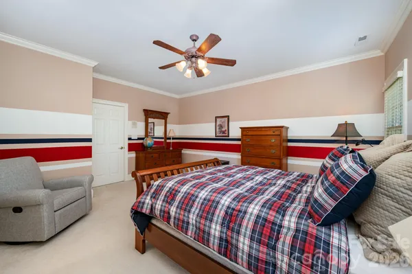 a bedroom with a bed and ceiling fan