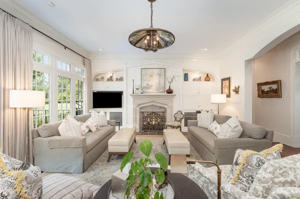 a living room with furniture a flat screen tv and a fireplace