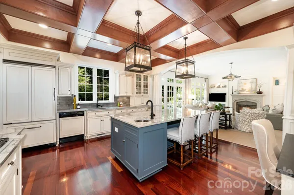 a kitchen with stainless steel appliances granite countertop a stove and wooden floor