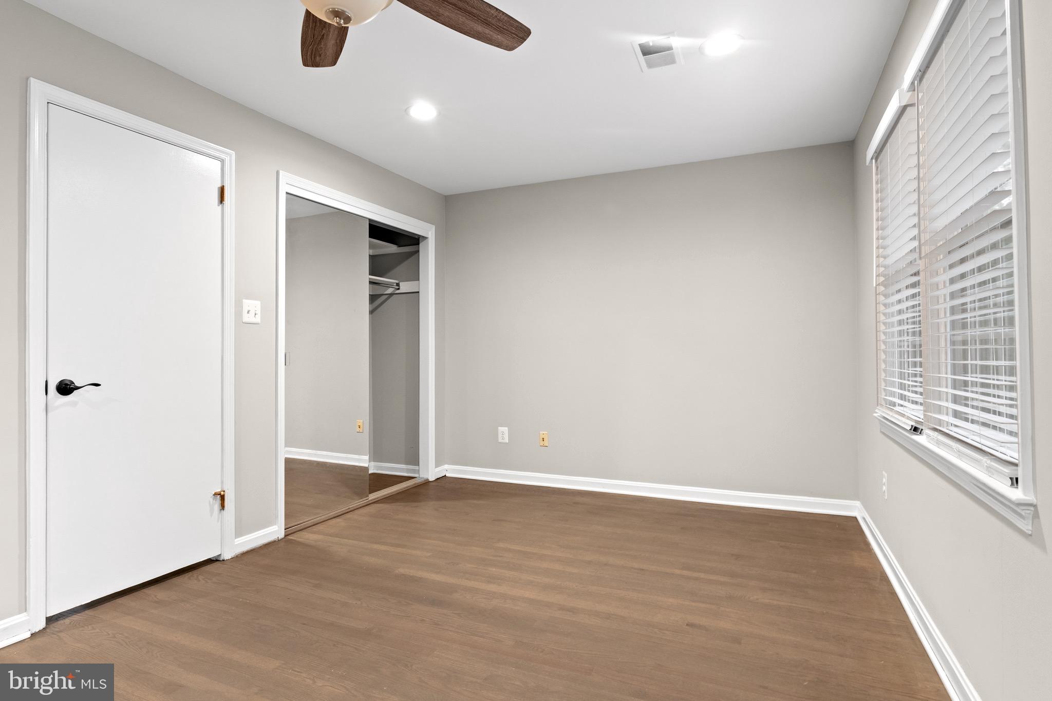4727 Exeter Street Annandale, VA 22003 - Photo 12 of 35 an empty room with wooden floor and windows