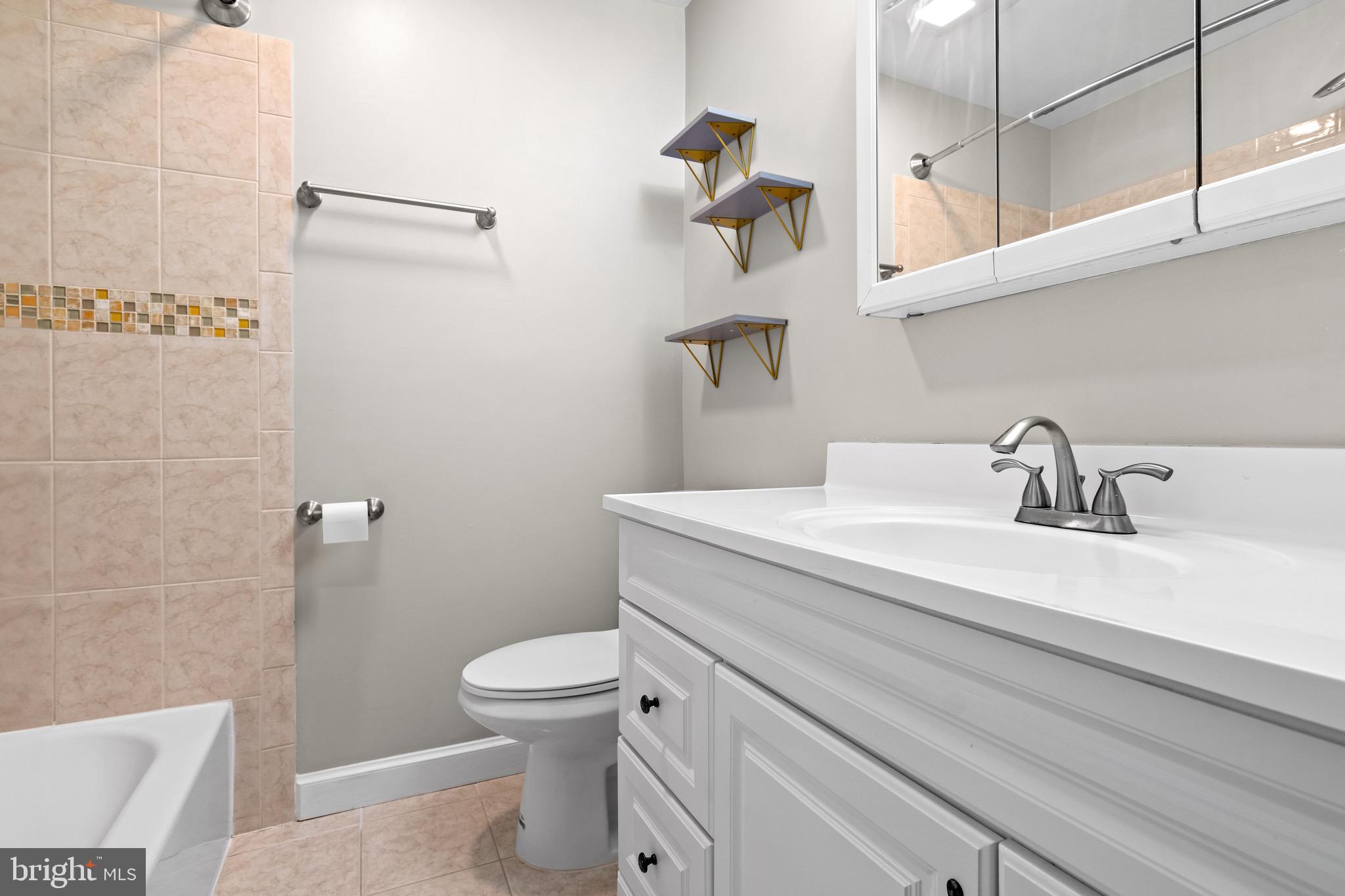 4727 Exeter Street Annandale, VA 22003 - Photo 21 of 35 a bathroom with a sink a toilet and shower