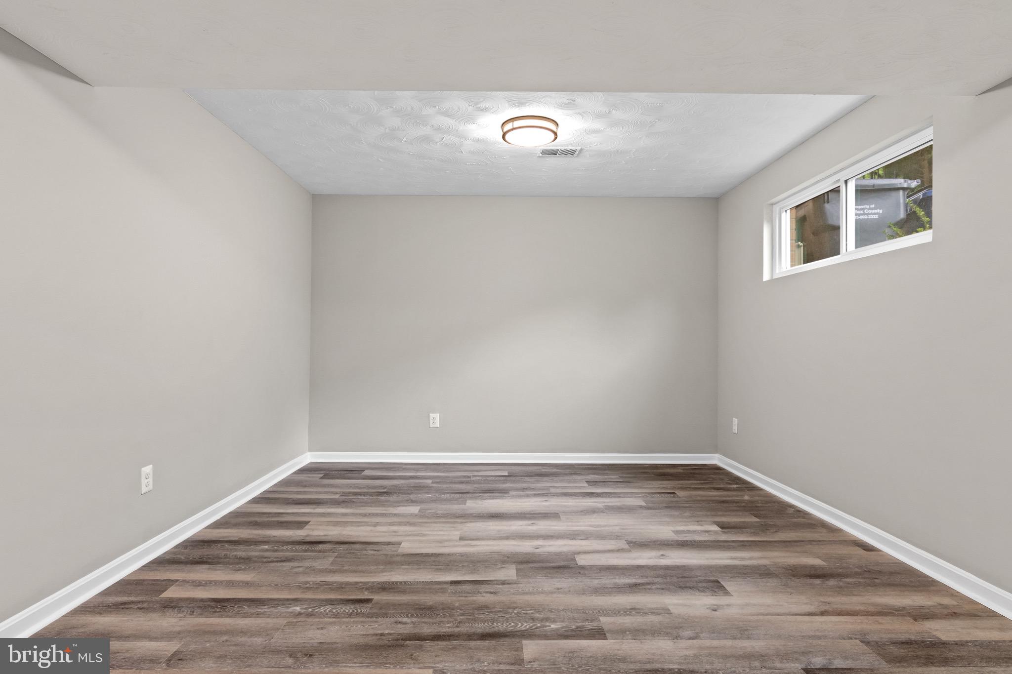4727 Exeter Street Annandale, VA 22003 - Photo 23 of 35 a view of an empty room with wooden floor and a window