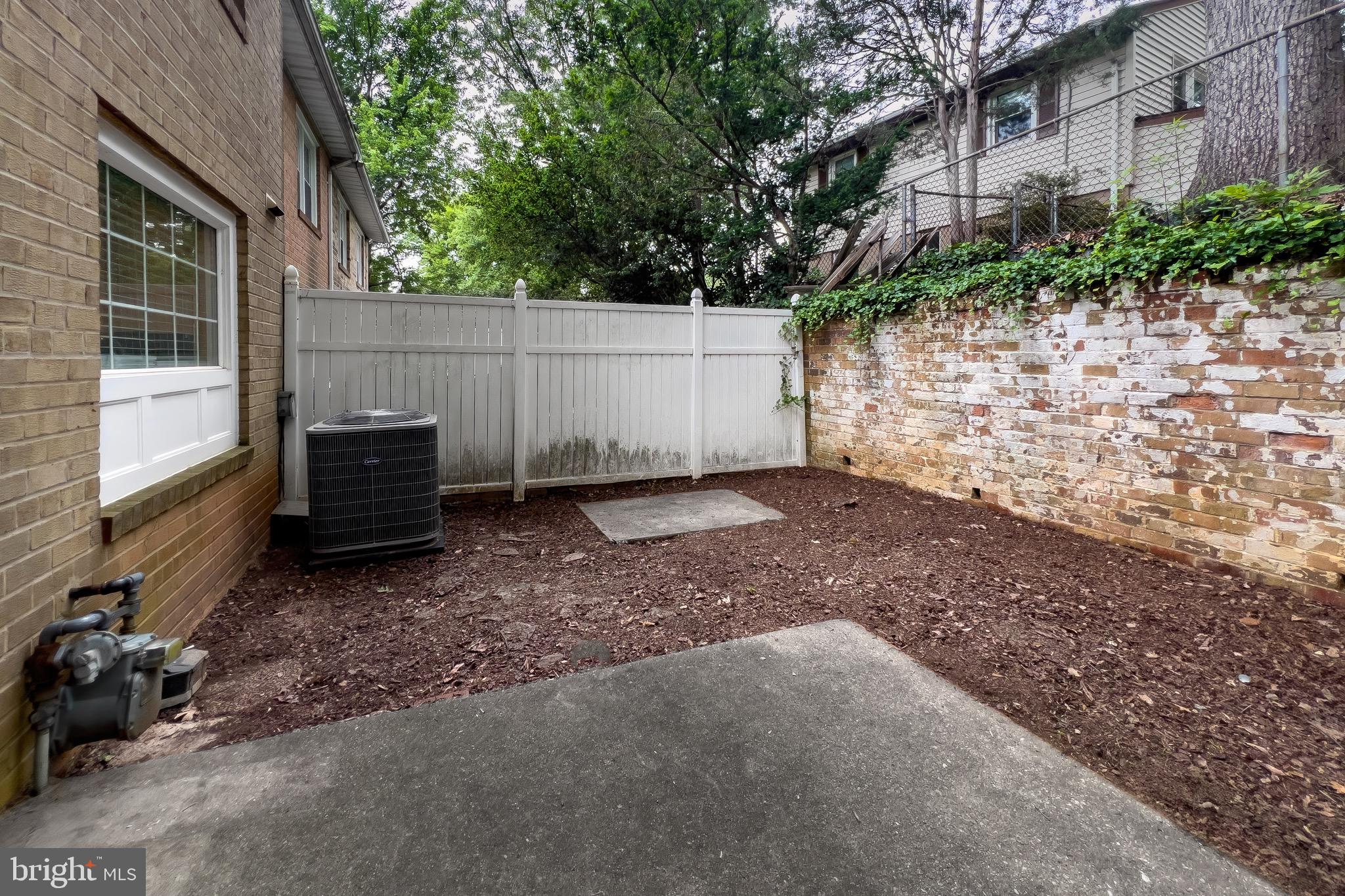 4727 Exeter Street Annandale, VA 22003 - Photo 31 of 35 a backyard of a house with a bench and trees