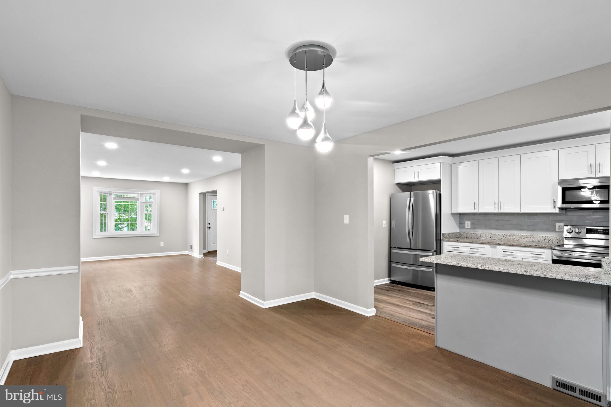 4727 Exeter Street Annandale, VA 22003 - Photo 6 of 35 a view of a kitchen island wooden floor and stainless steel appliances