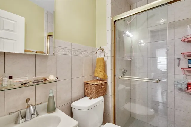 a bathroom with a toilet and a shower