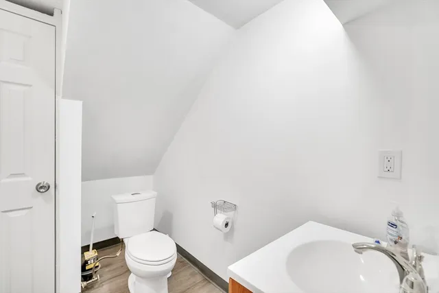 a white toilet sitting next to a white sink