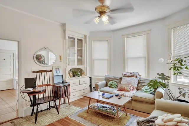 a living room with furniture a chandelier and a window