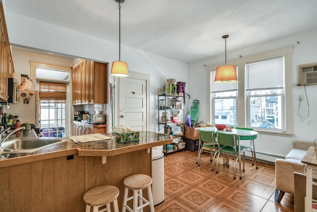33 Shannon Street, Unit 1 Boston, MA 02135 - Photo 5 of 15 a living room with furniture a window and chandelier