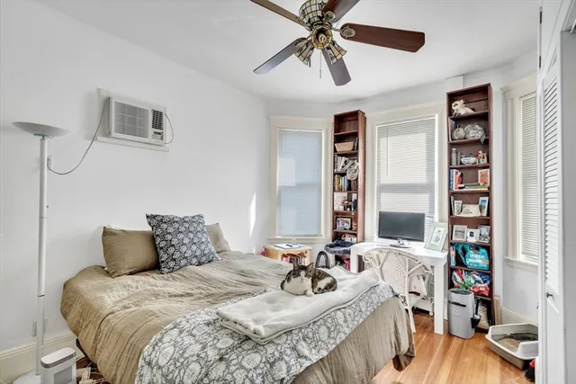a bedroom with a bed a bookshelf and a chandelier