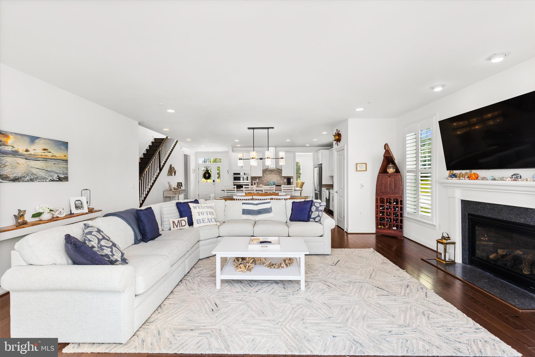 10119 Fast Colors Lane Berlin, MD 21811 - Photo 14 of 43 a living room with furniture a flat screen tv and a fireplace
