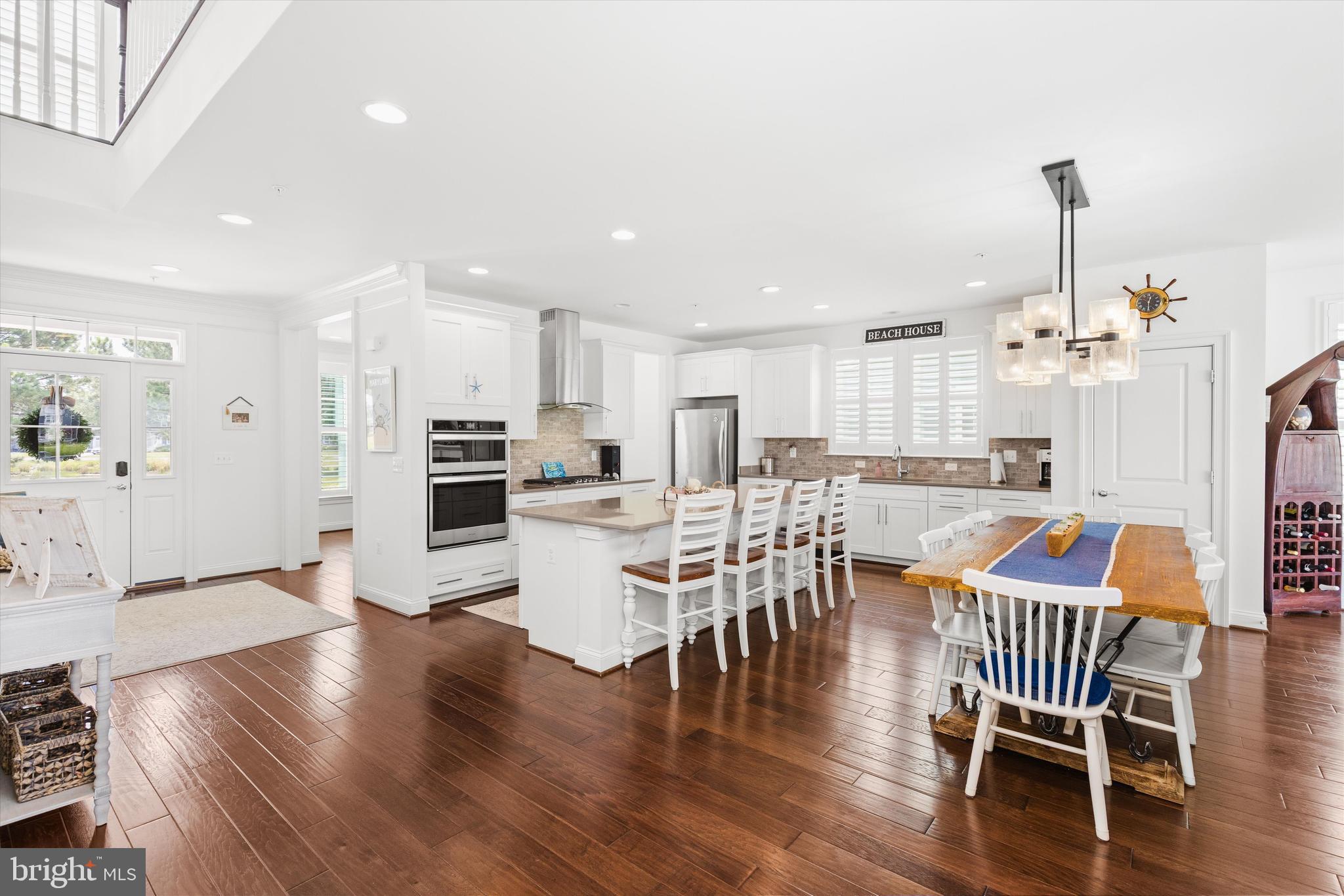 10119 Fast Colors Lane Berlin, MD 21811 - Photo 17 of 43 a view of a dining room with furniture wooden floor and chandelier