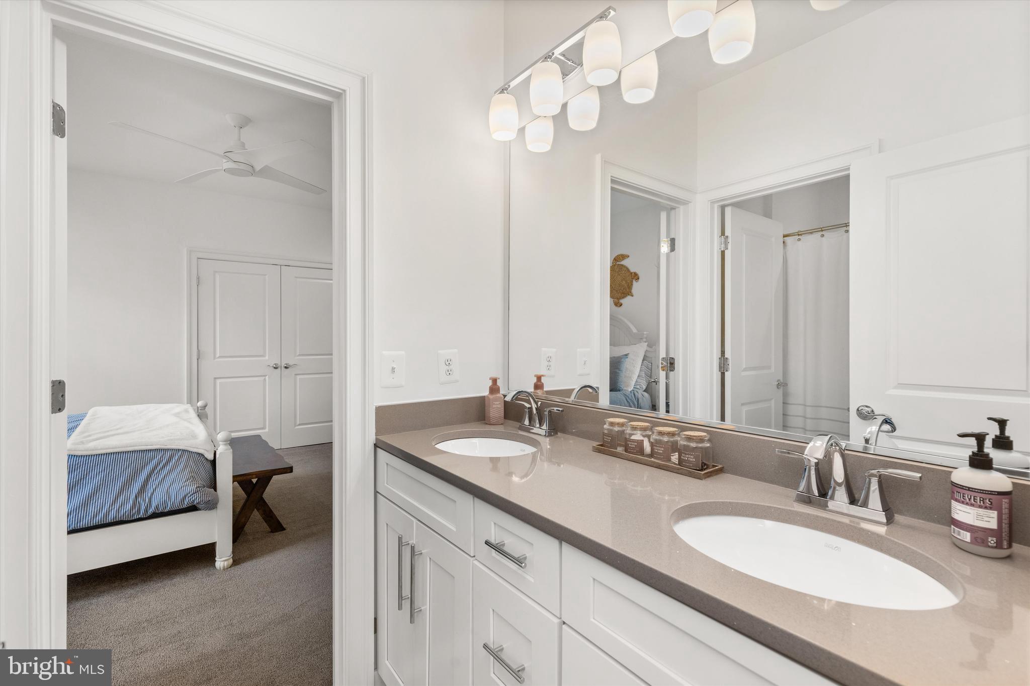 10119 Fast Colors Lane Berlin, MD 21811 - Photo 37 of 43 a en suite bathroom with a double vanity sink and a mirror